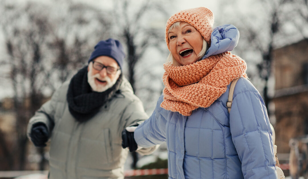Happy elderly couple having fun in winter weather